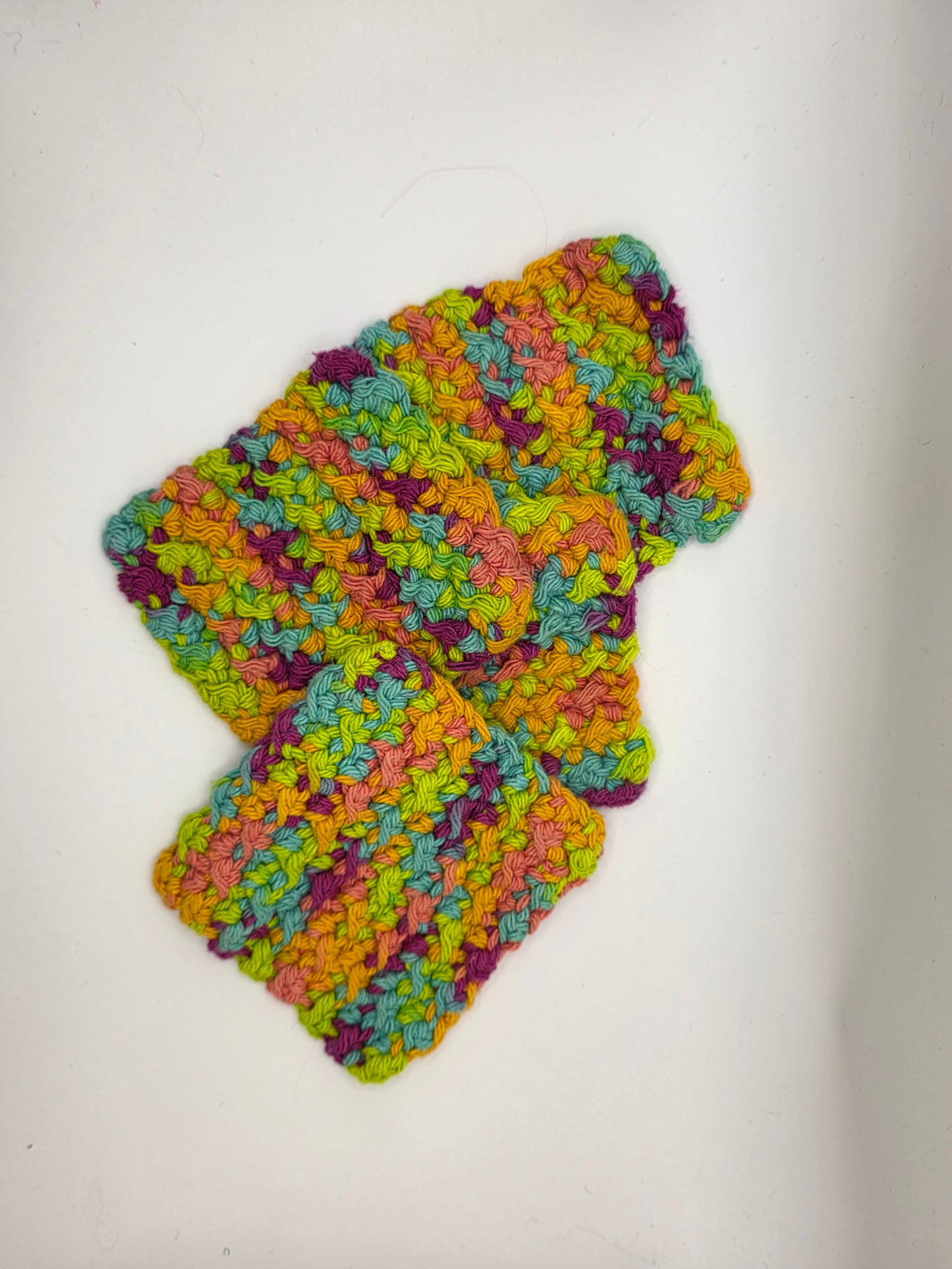 Colorful crocheted dishcloth on a white background